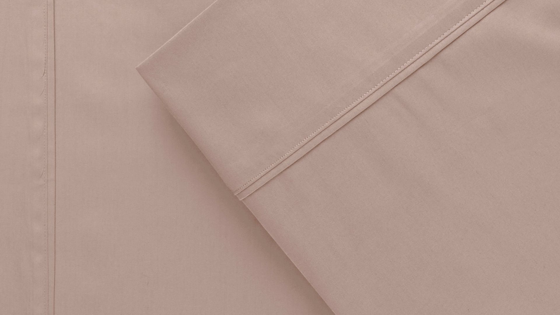 Close up view of muted pink bamboo cotton bed sheets