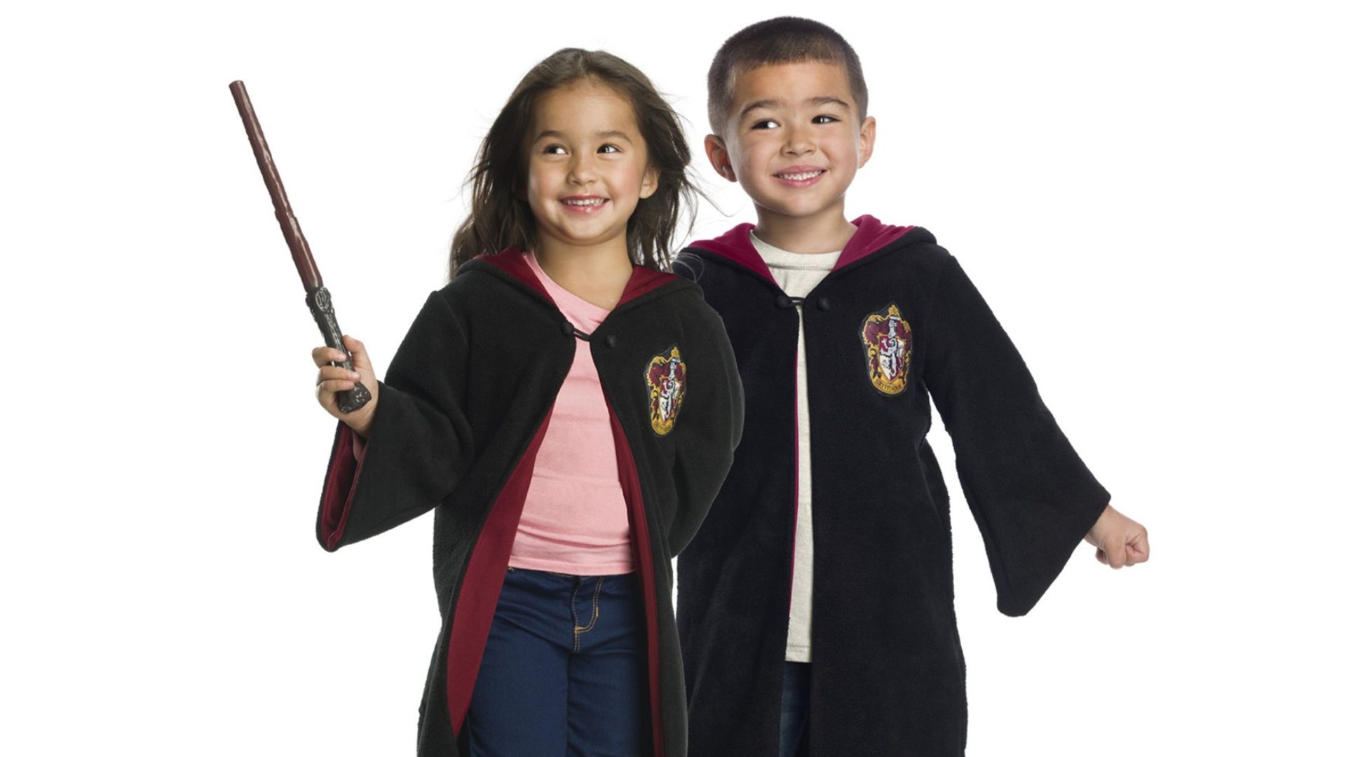 Kids wearing Harry Potter Gryffindor House Robes and toy wand