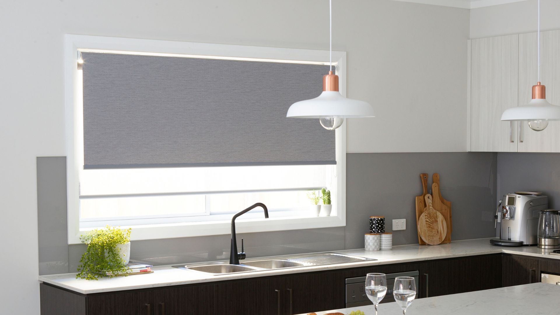 Layered sheer white and light grey kitchen roller blinds