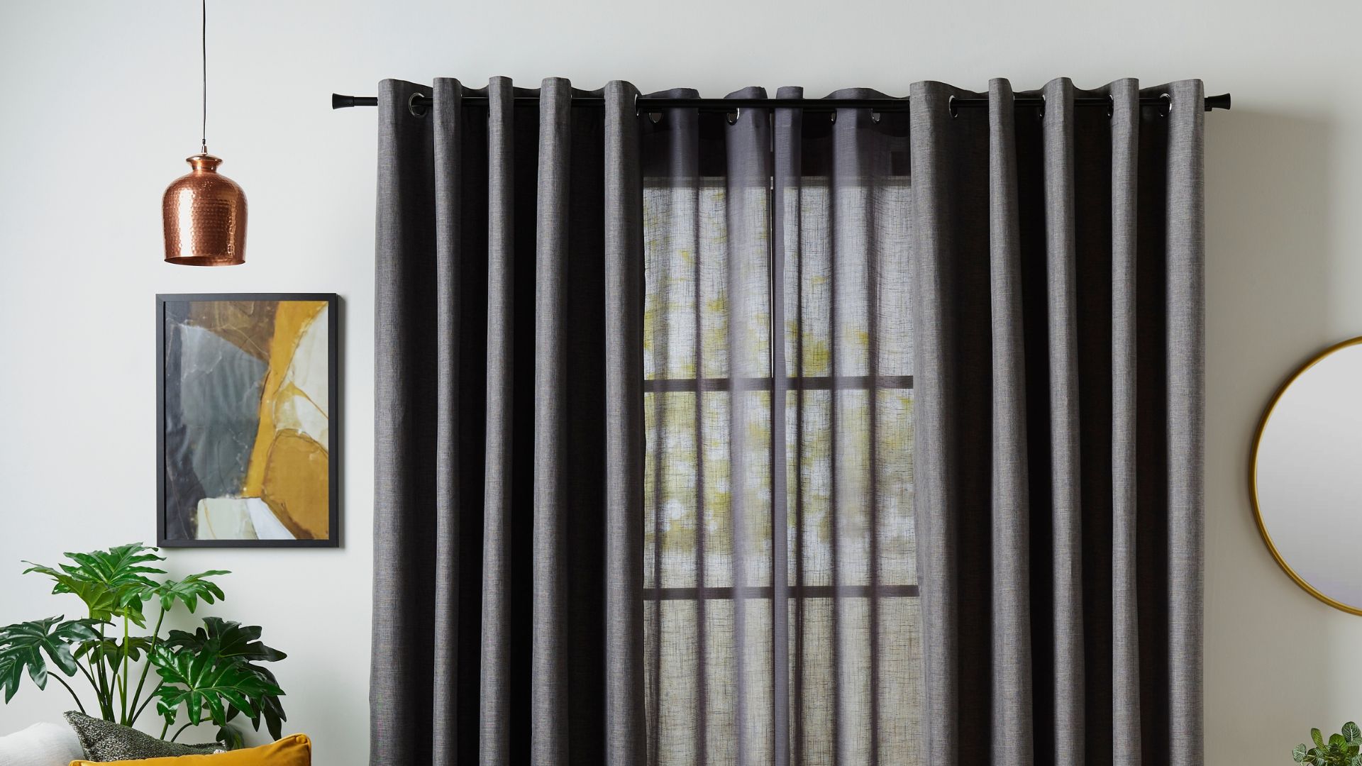 Sheer curtains layered with block out dark grey curtains