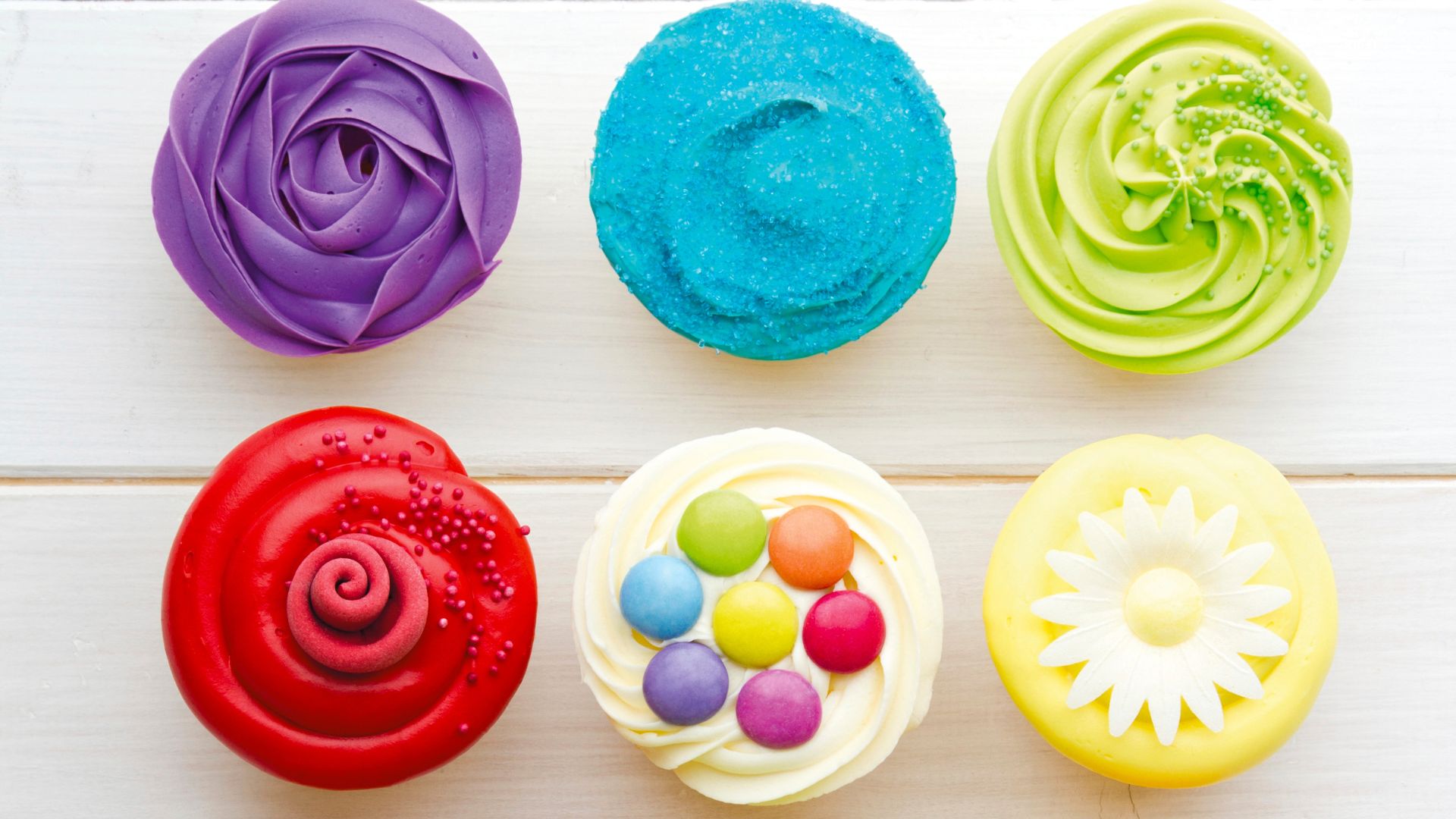 Decorated cupcakes with different piping bag tips